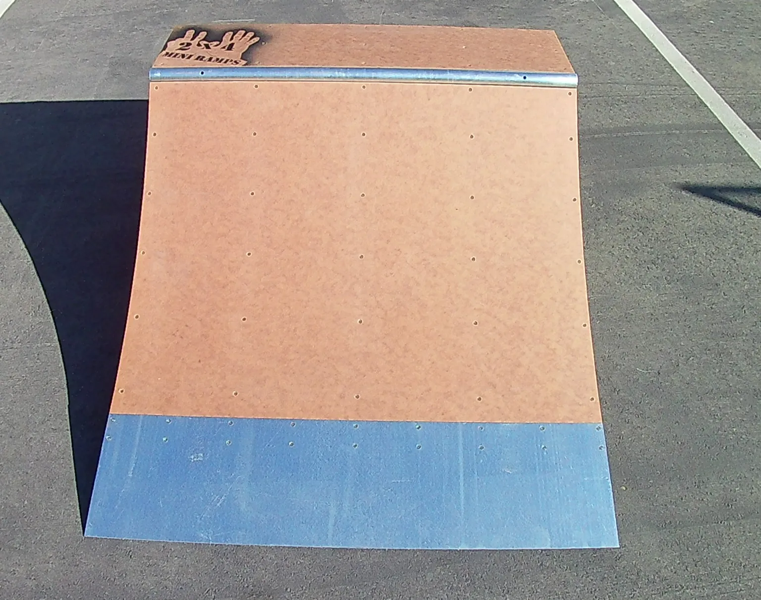 Straight on view of two foot high by four foot wide quarter pipe