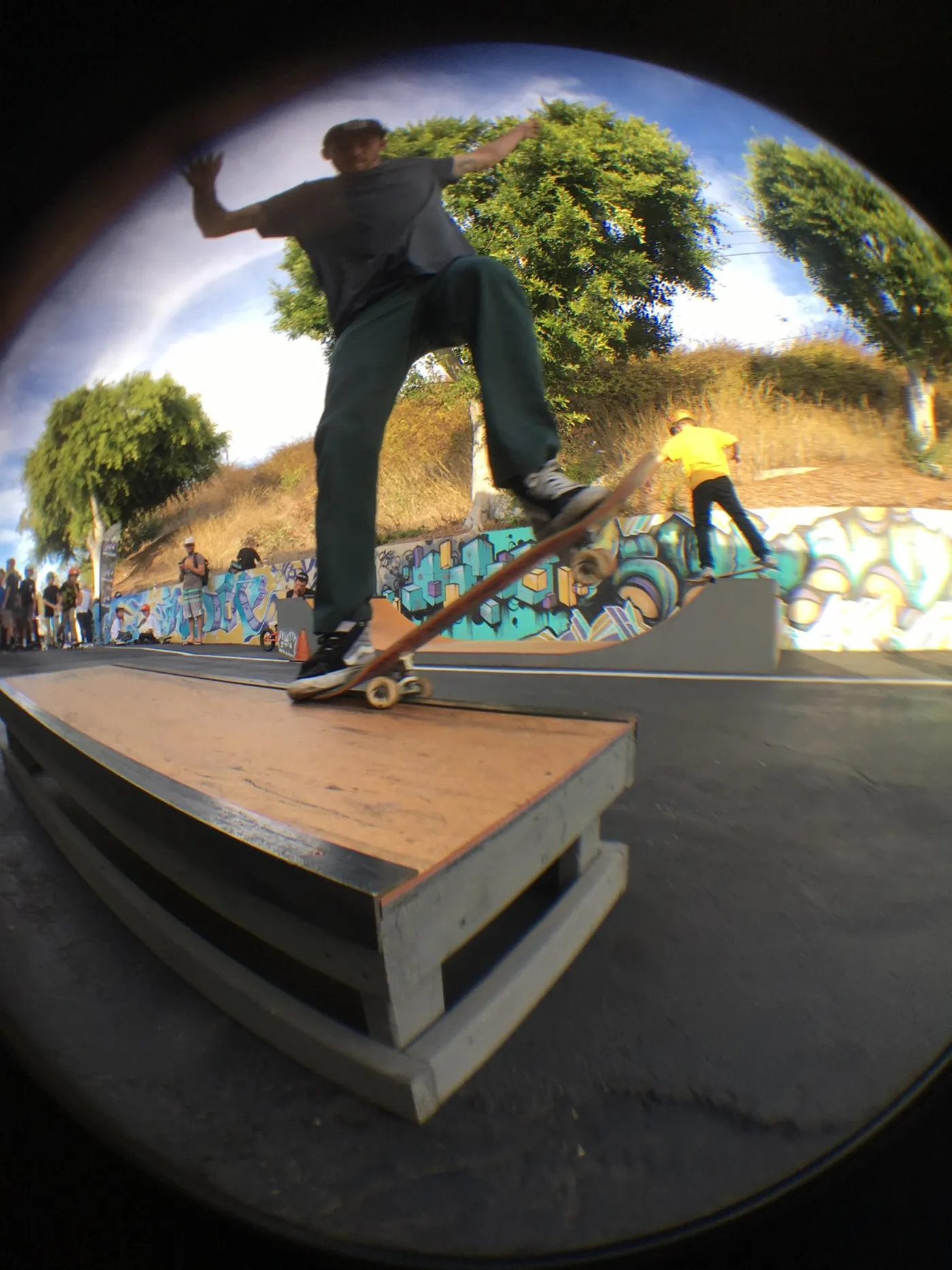 One foot high grind box with skater doing a 5-0 grind on it