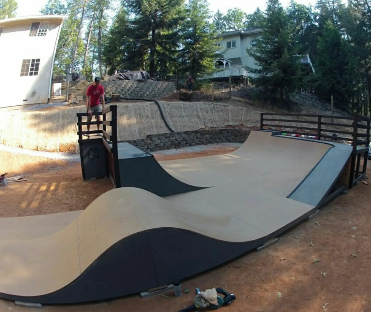 Side view of custom backyard flow park with big extension wall